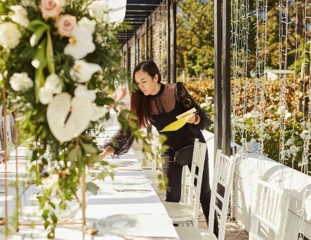Wedding planner carefully perfecting table decoration - the art of creating perfect moments in the Caribbean