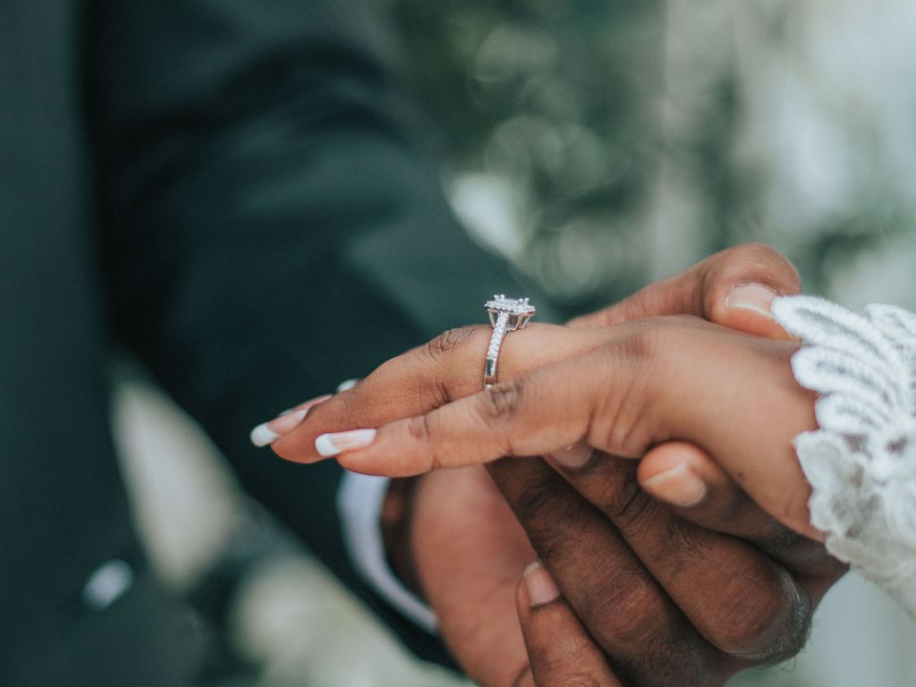 Close-up of the ring exchange between the couple, an intimate and precious moment.