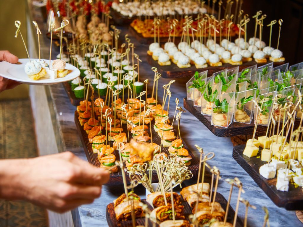 Gourmet cocktail buffet for Caribbean wedding reception with refined selection of canapés and appetizers on elegant display stands